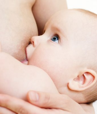 Little baby girl breastfeeding