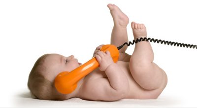 Baby holding telephone handset
