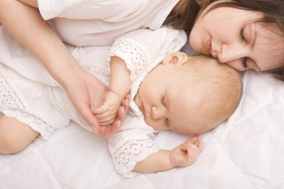 Cute baby sleeping with mother