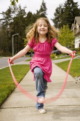 Cute little girl skipping rope